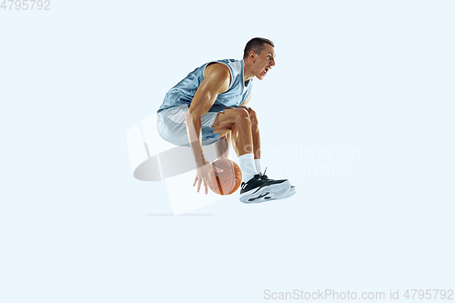 Image of Young caucasian basketball player against white studio background