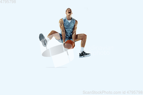 Image of Young caucasian basketball player against white studio background