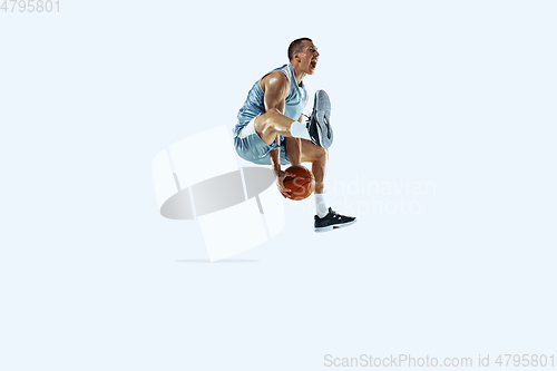 Image of Young caucasian basketball player against white studio background