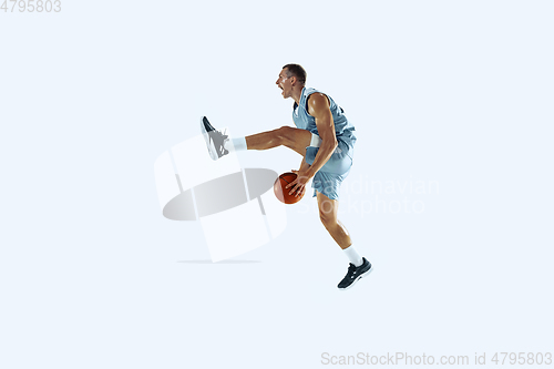 Image of Young caucasian basketball player against white studio background