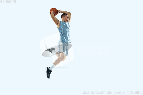 Image of Young caucasian basketball player against white studio background