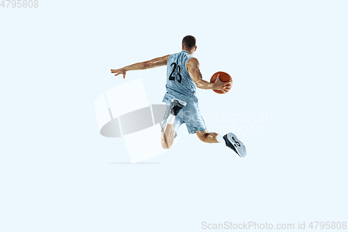 Image of Young caucasian basketball player against white studio background