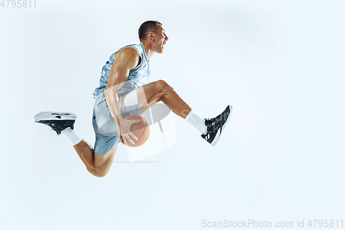 Image of Young caucasian basketball player against white studio background