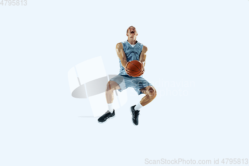 Image of Young caucasian basketball player against white studio background