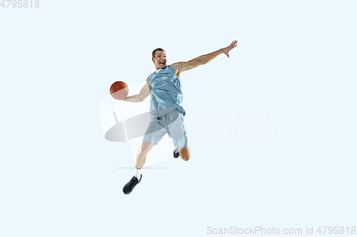 Image of Young caucasian basketball player against white studio background