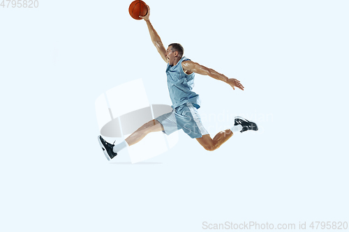 Image of Young caucasian basketball player against white studio background