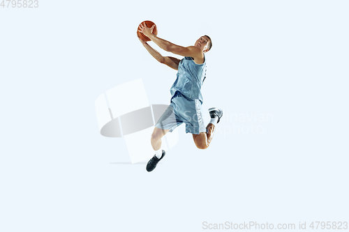 Image of Young caucasian basketball player against white studio background