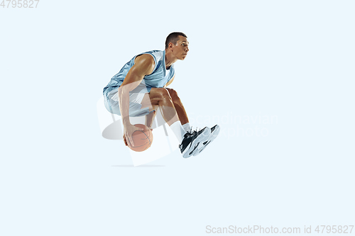 Image of Young caucasian basketball player against white studio background