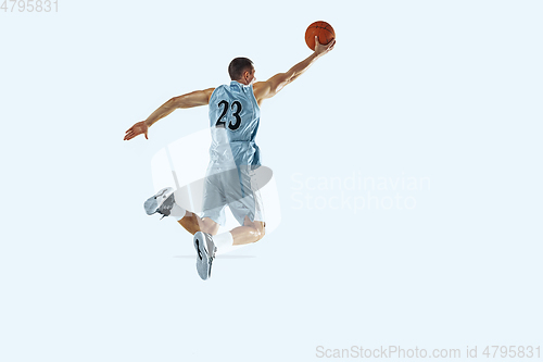 Image of Young caucasian basketball player against white studio background