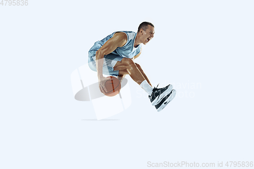 Image of Young caucasian basketball player against white studio background