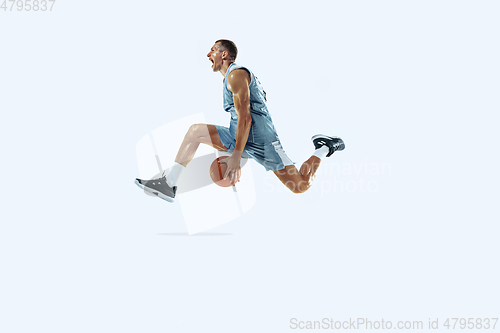 Image of Young caucasian basketball player against white studio background