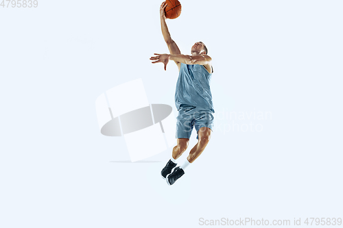 Image of Young caucasian basketball player against white studio background