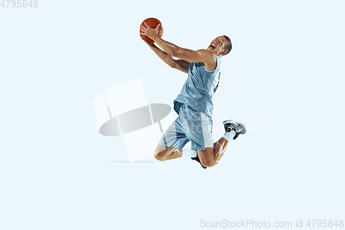 Image of Young caucasian basketball player against white studio background