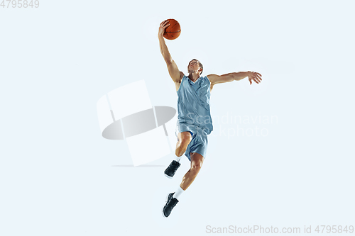 Image of Young caucasian basketball player against white studio background