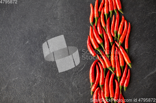 Image of red chili or cayenne pepper on slate stone surface