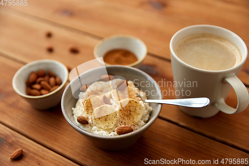 Image of oatmeal with banana and almond on wooden table