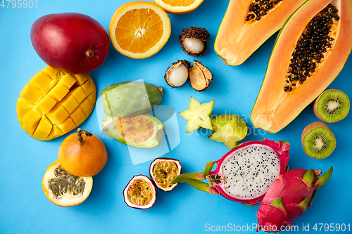 Image of different exotic fruits on blue background