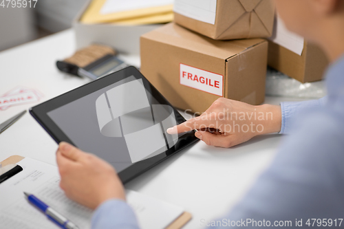 Image of hands with tablet pc and clipboard at post office