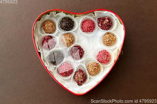 Image of candies in red heart shaped chocolate box