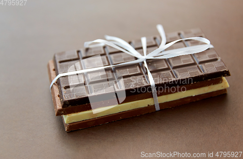 Image of different kinds of chocolate on brown background