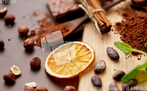 Image of chocolate with hazelnuts, cocoa beans and orange