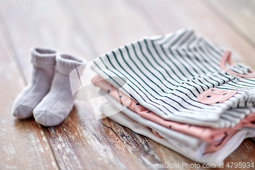 Image of close up of baby clothes on wooden table