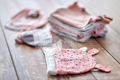 Image of close up of baby clothes on wooden table