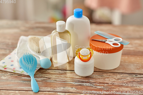 Image of baby accessories for bathing on wooden table