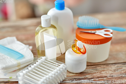 Image of baby accessories for bathing on wooden table