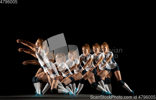 Image of Young female volleyball player isolated on black studio background