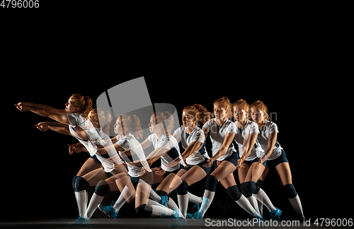 Image of Young female volleyball player isolated on black studio background