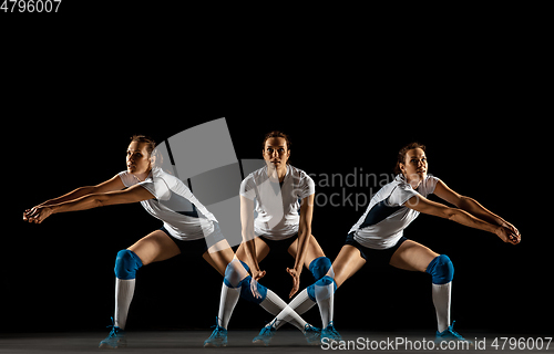 Image of Young female volleyball player isolated on black studio background