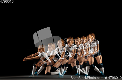 Image of Young female volleyball player isolated on black studio background