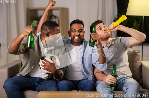 Image of friends or soccer fans with ball and beer at home