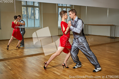 Image of beautiful couple dancing tango