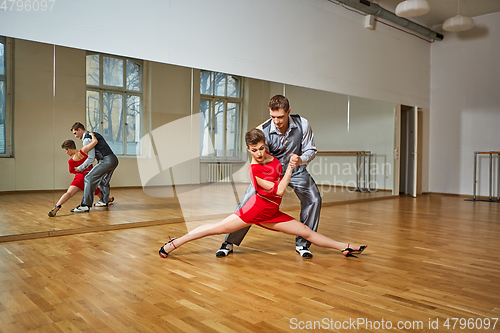 Image of beautiful couple dancing tango