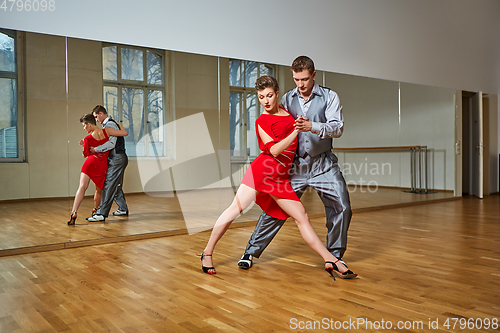 Image of beautiful couple dancing tango