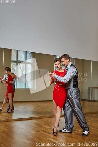 Image of beautiful couple dancing tango