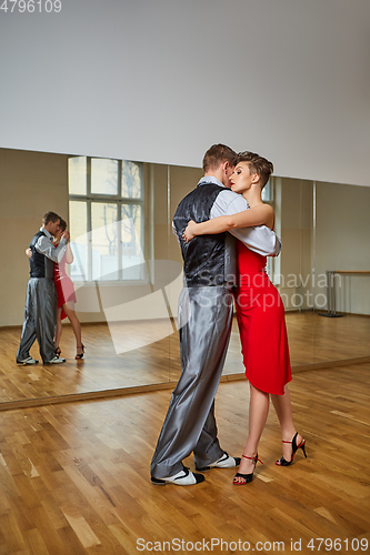 Image of beautiful couple dancing tango