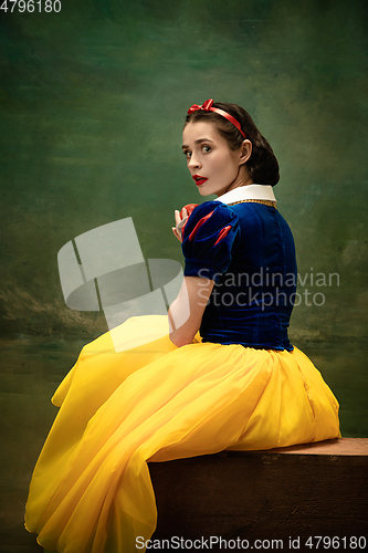 Image of Young ballet dancer as a Snow White with poisoned apple in forest