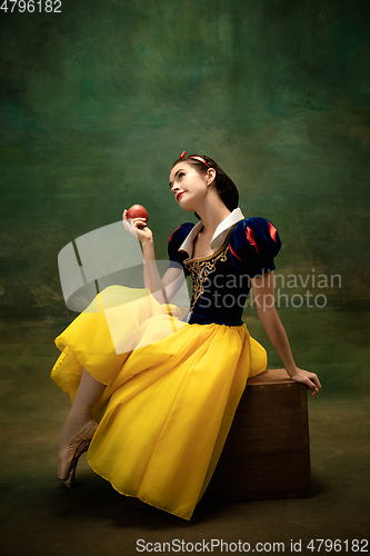 Image of Young ballet dancer as a Snow White with poisoned apple in forest