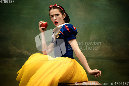 Image of Young ballet dancer as a Snow White with poisoned apple in forest