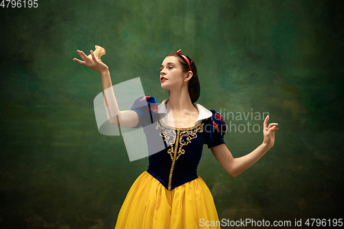 Image of Young ballet dancer as a Snow White with poisoned apple in forest