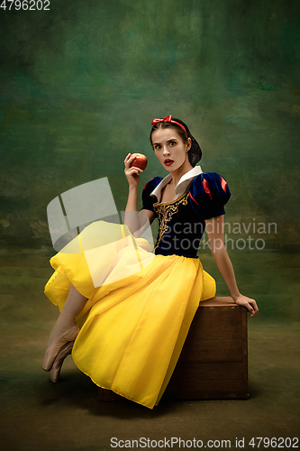 Image of Young ballet dancer as a Snow White with poisoned apple in forest