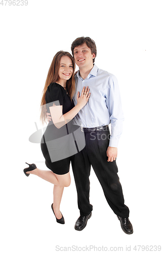 Image of Happy young couple standing in dress and pants