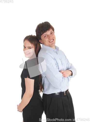 Image of Young couple standing back to back