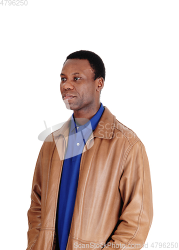 Image of Serious African man standing in leather jacket