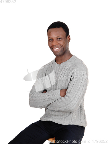 Image of Happy African man smiling, sitting
