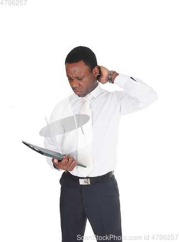 Image of African business man paper, scratching his head