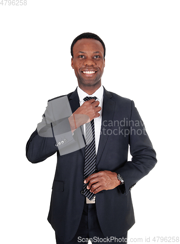 Image of African business man fixing his tie